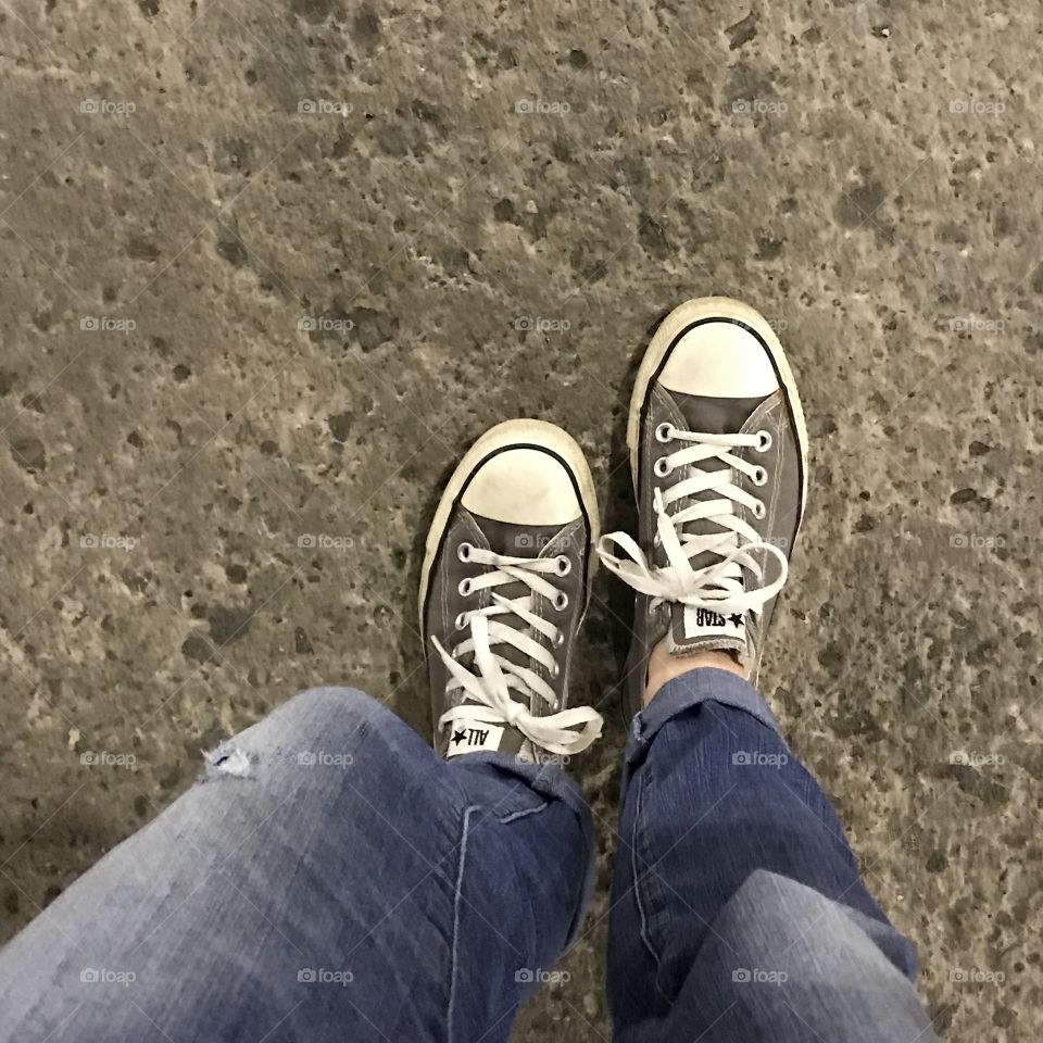 Gray All Star Chuck Taylor Shoes on Concrete Floor