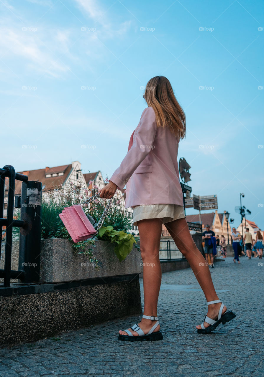 Pink outfit and the city.