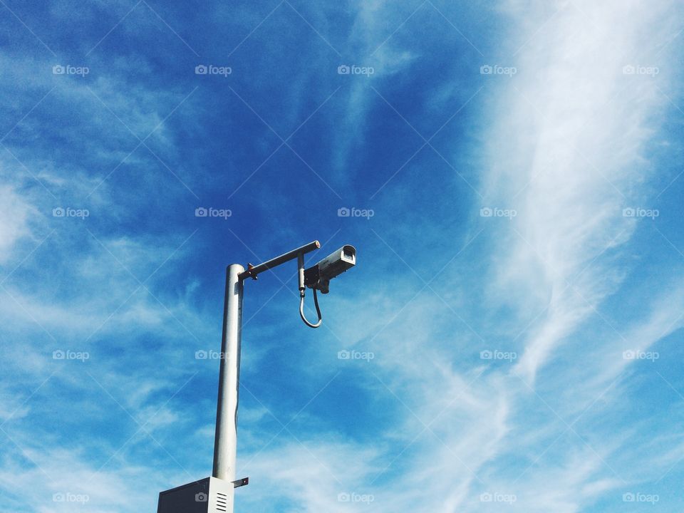 Security camera in blue sky