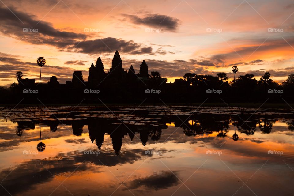 Angkor Wat during sunrise. Colorful sunrise with silhouette and reflection of Angkor Wat in Cambodia.