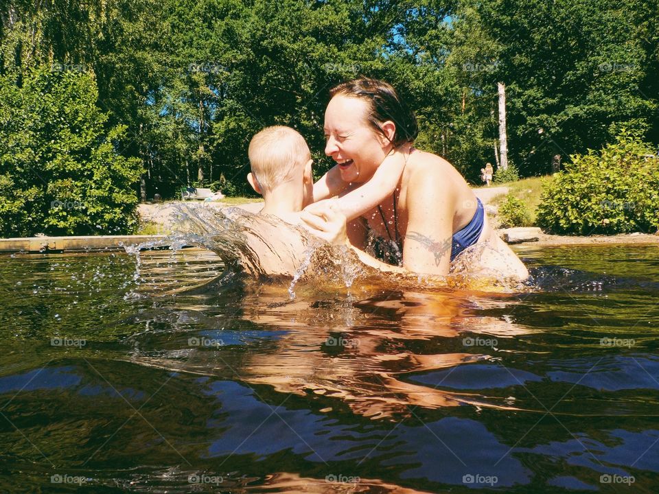 Mother and son having fun in the lake