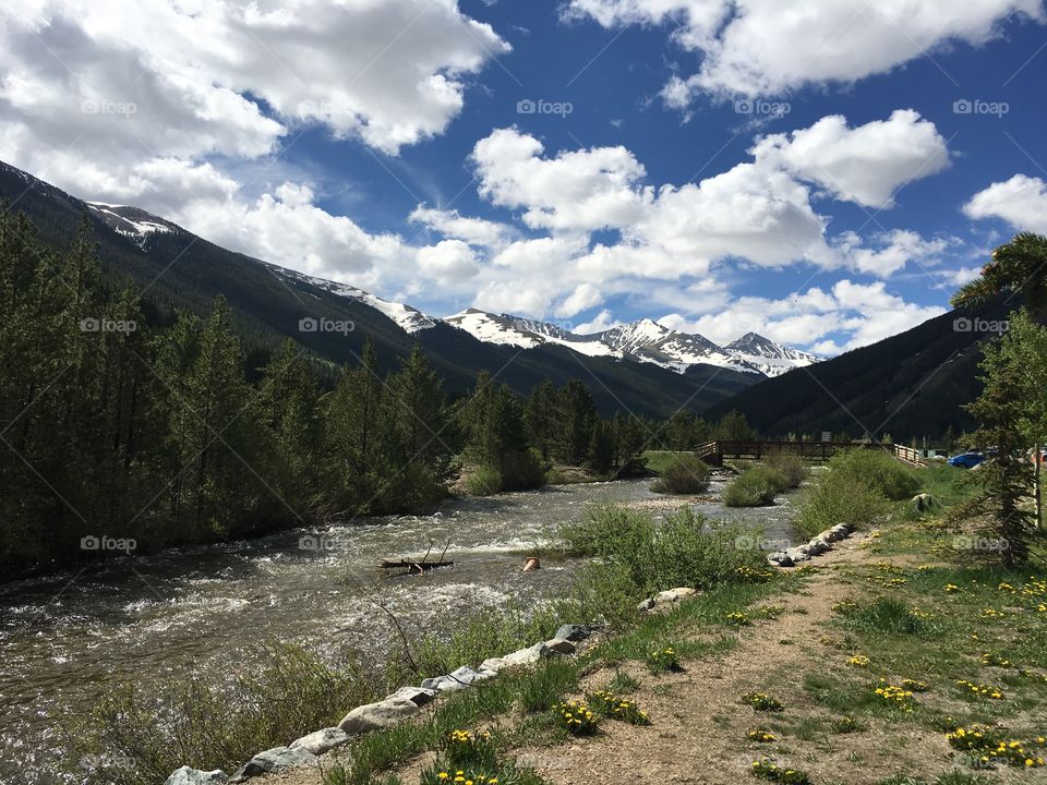 A Colorado morning, in early July. Beautiful blue sky, water rushing down the mountains, and green along the Highway. 