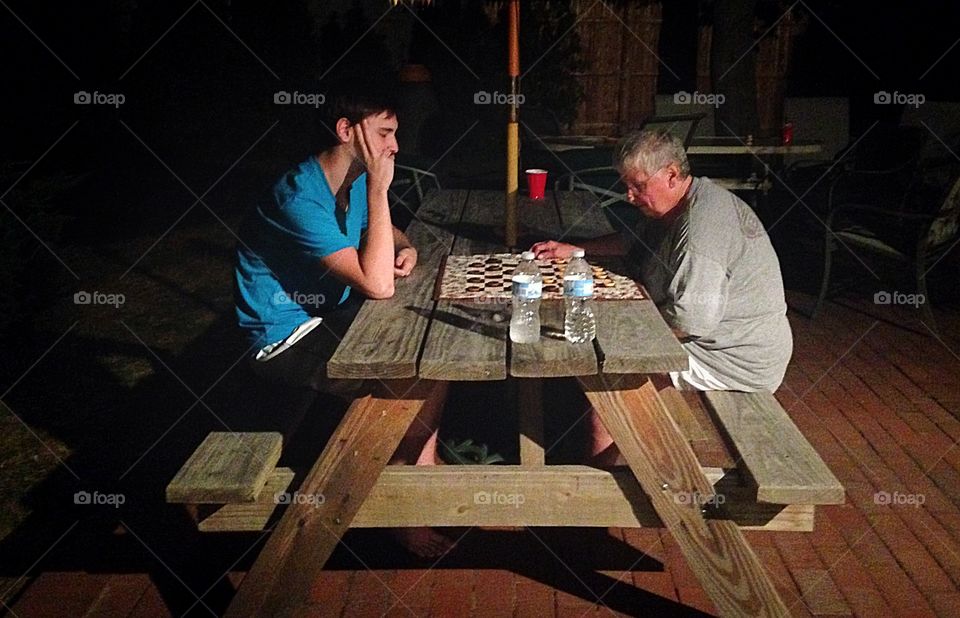 Nana and grandson in a heated checkers game one summer night...
