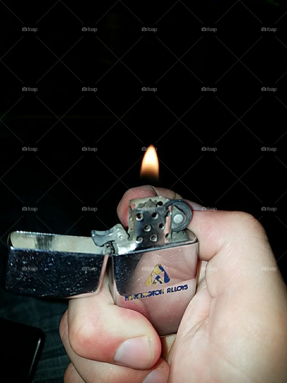 holding a lighter, black contrast, dark and bright