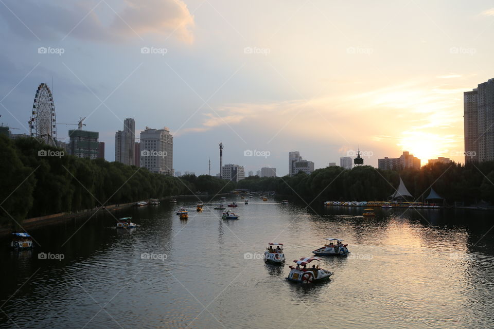 People enjoying boating during sunset