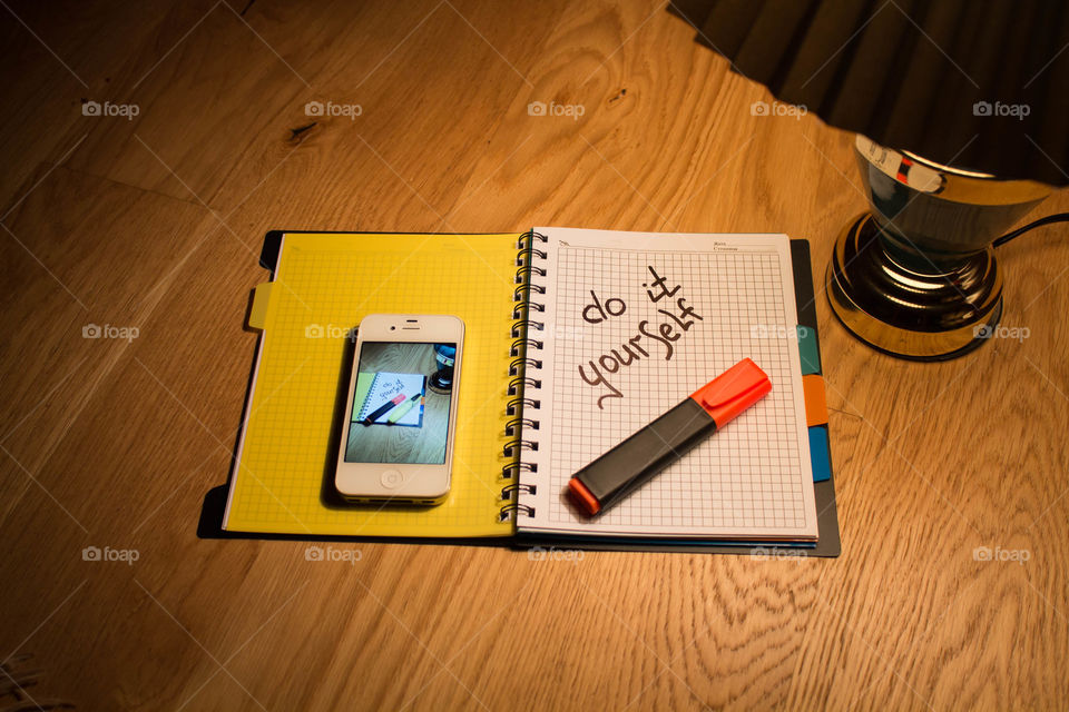 Motivational letter in a notebook on the desktop under the light of a lamp