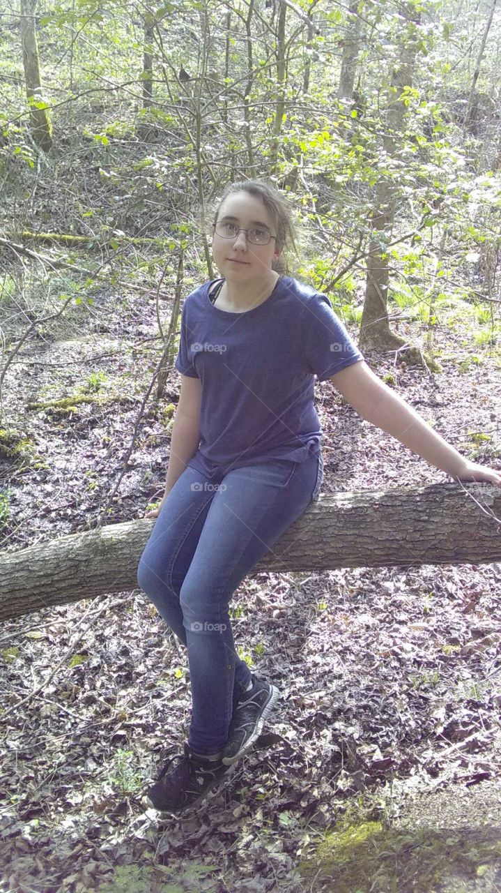 Girl sitting in the forest