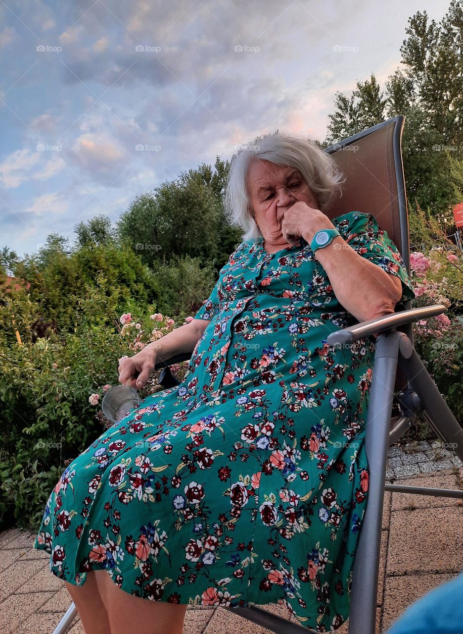 angry senior woman in a garden