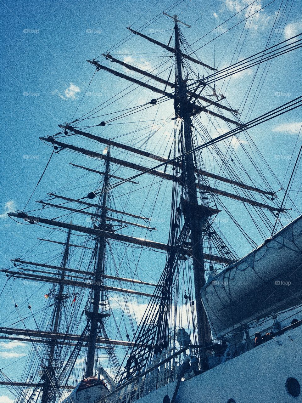 Sun shining through masts on tall ship