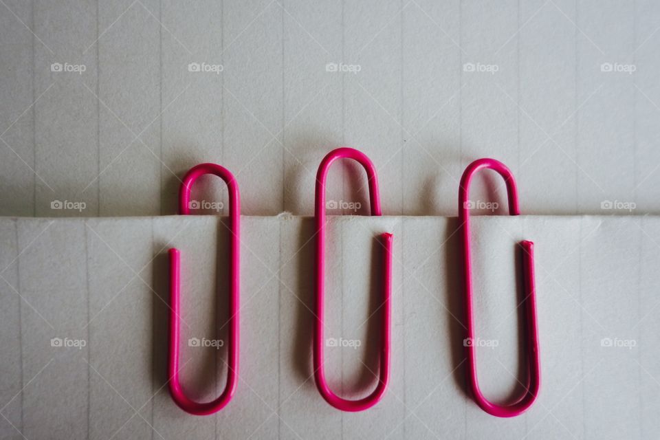 Pink clips on paper