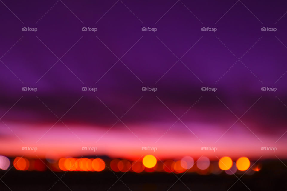 Sunset in bokeh with airport lights turned into bokeh pearls.