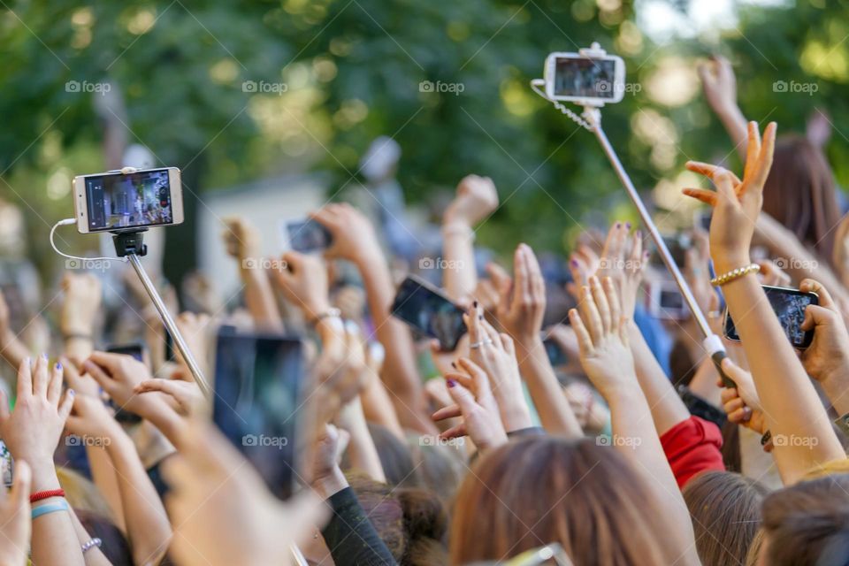 People cheering up at the outdoor concert