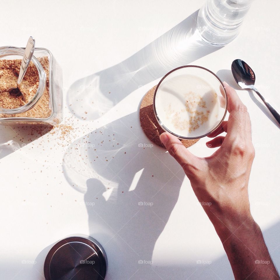 Person's hand holding hot drink