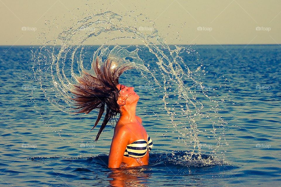 Sea games. Playing with the water in a beach in Rhodos island GREECE 