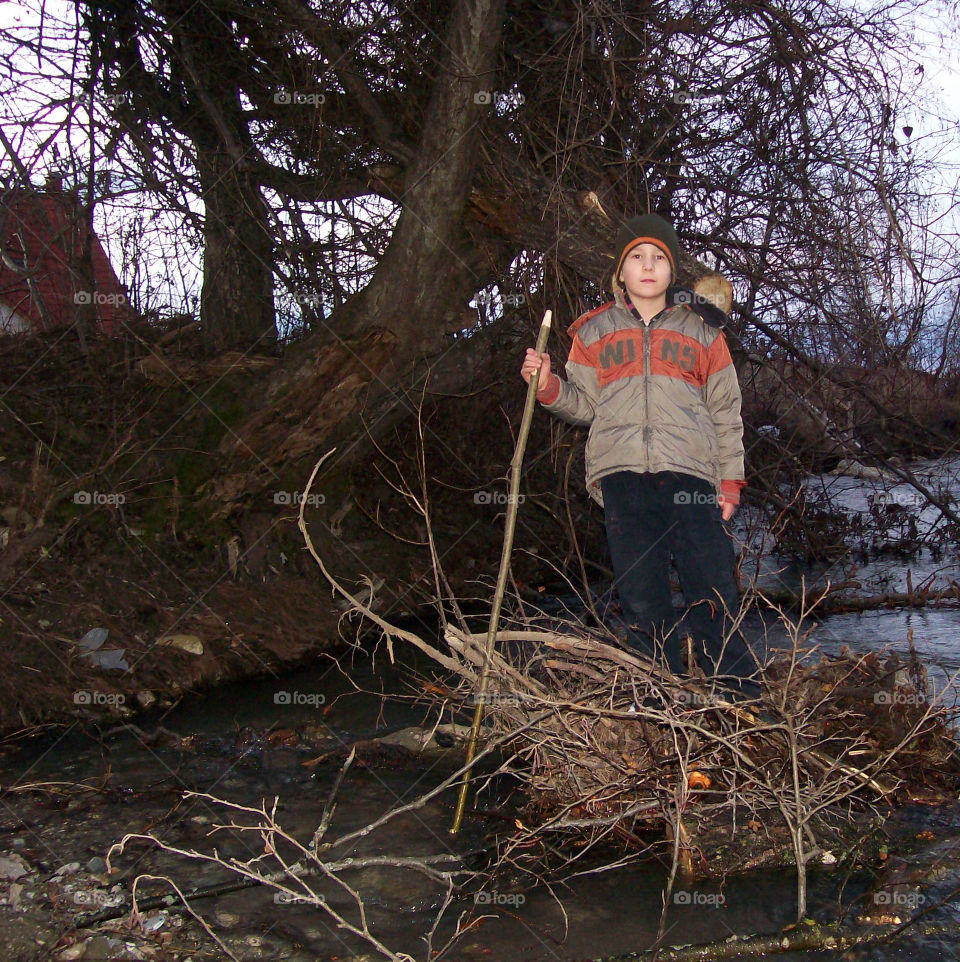 Portrait of boy holding stick in hand