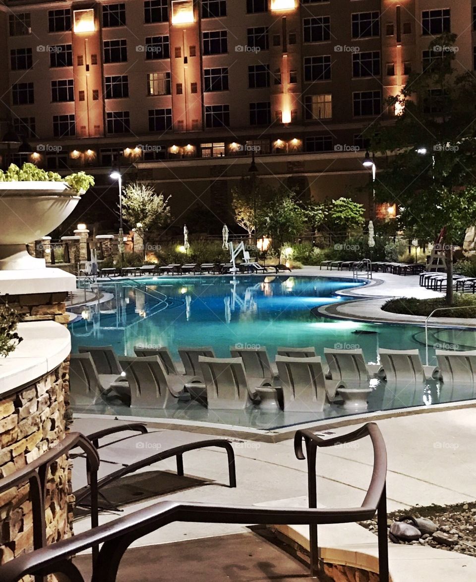 Hotel and resort swimming pool beautifully lighted against the dark of night!