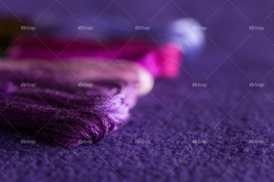 Skeins of purple thread of different tones