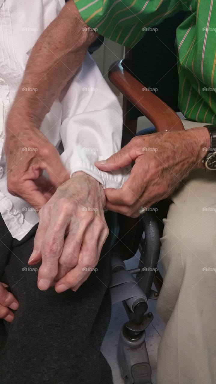 The hands of a 94 year old man, who drives 1 hour every day to be with his 92 year old wife who suffers with Alzheimers.