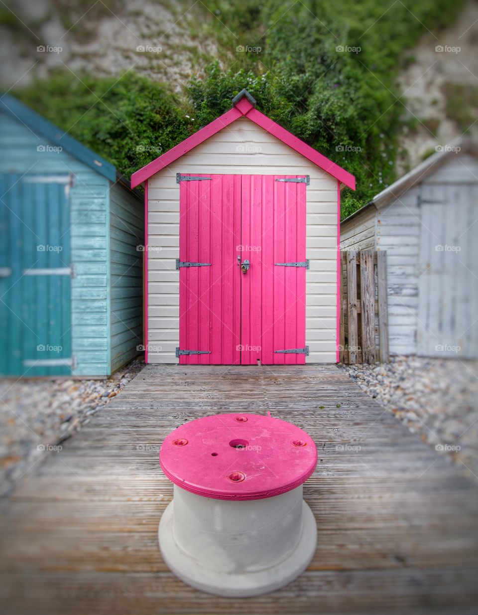 Pink Door. A pink  beach hut on a pebble beach in Devon, England.