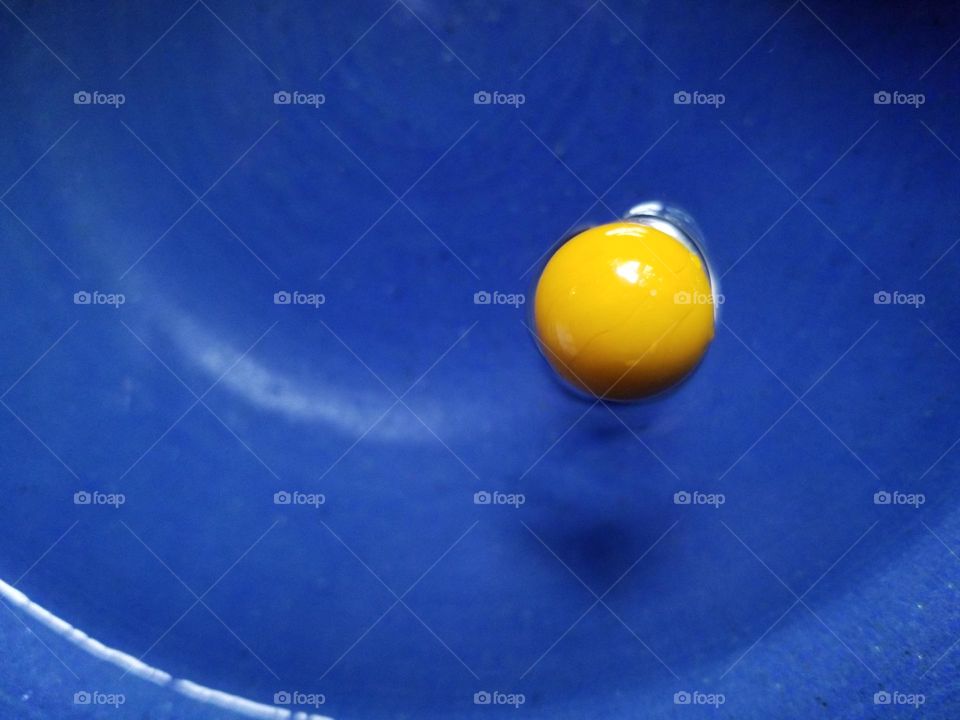 Magic yellow marble Floating in a blue bowl of Water