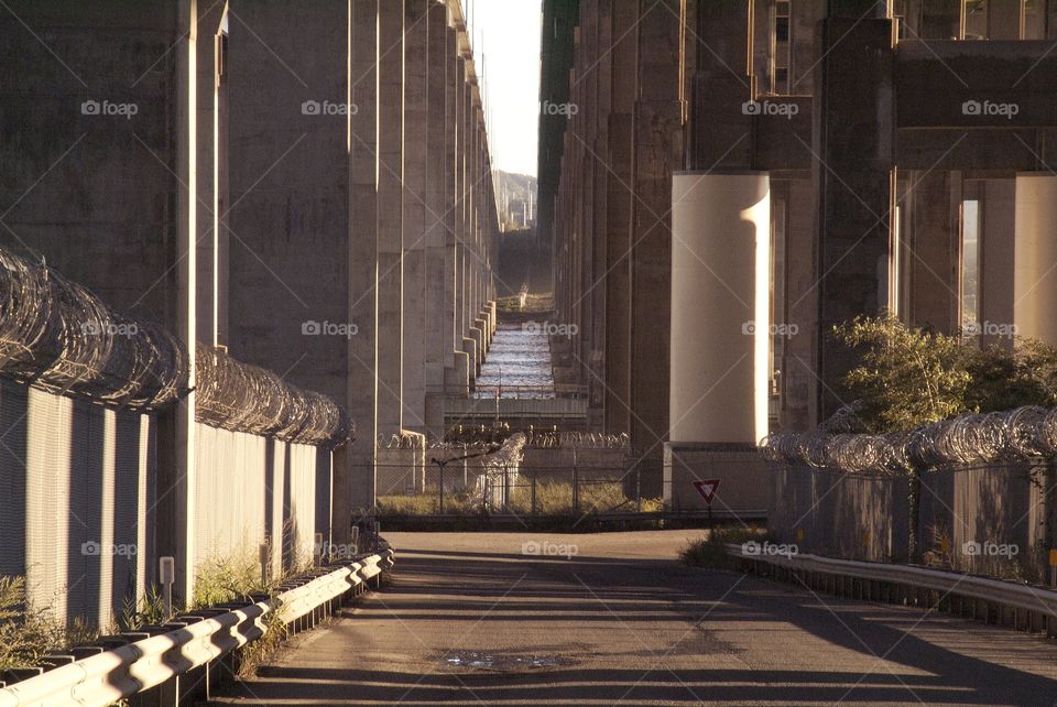 Barb wired fence and concrete pillars make up this highway city down below.