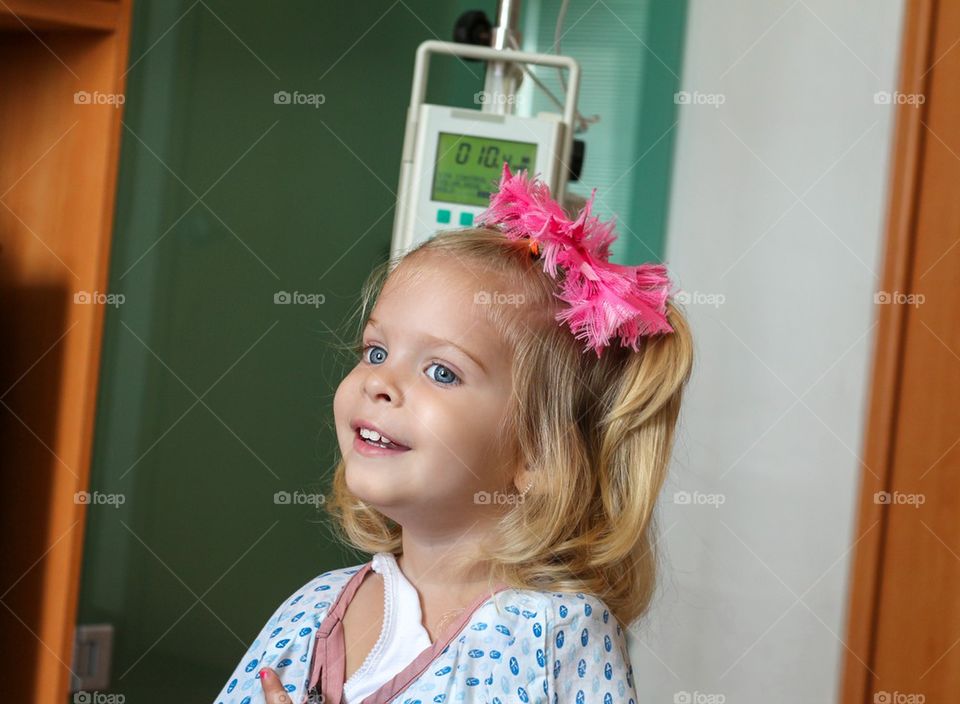Hospitalized girl with an iv drip bag
