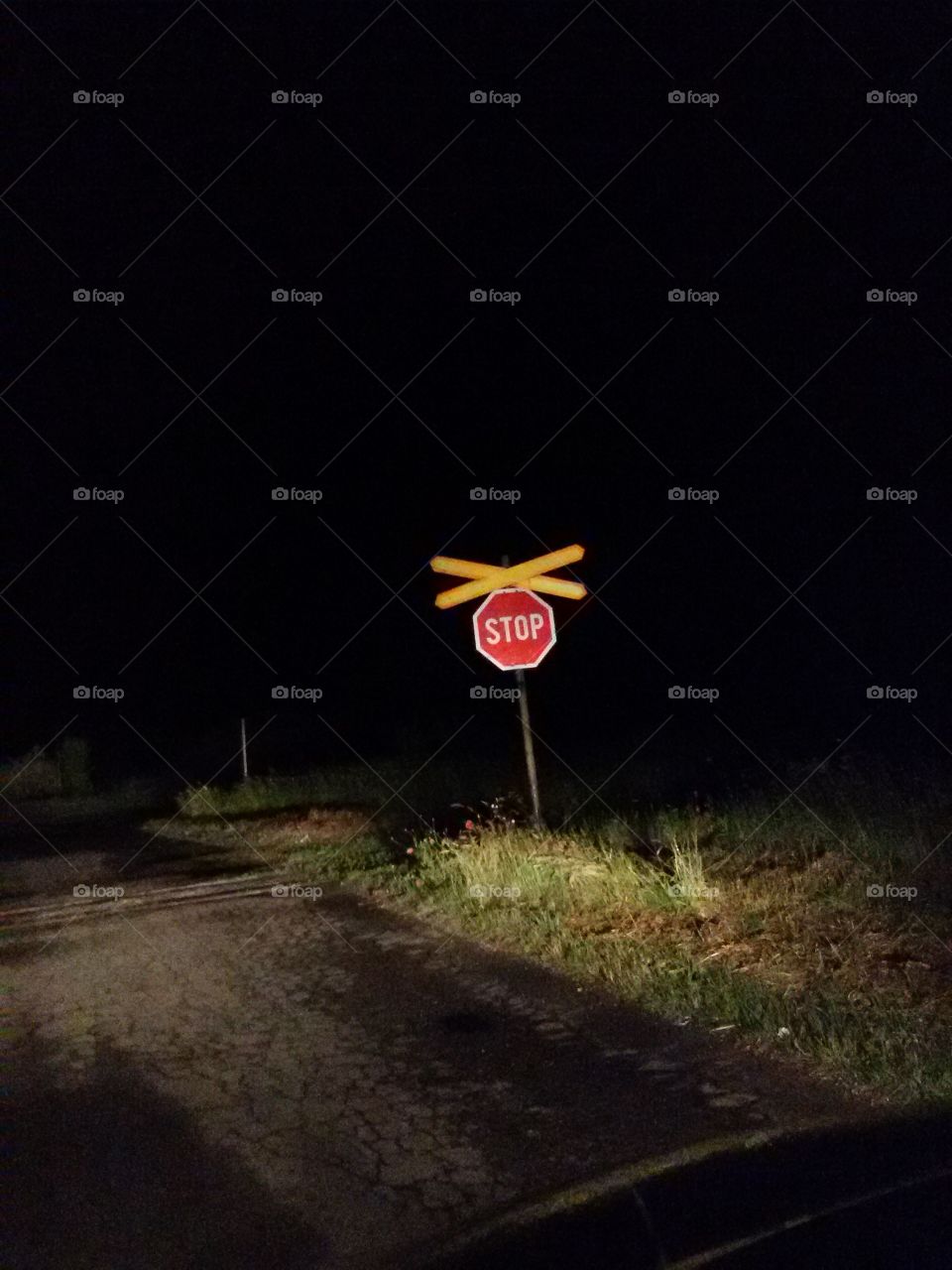 Stop sign on the road . Railway ahead