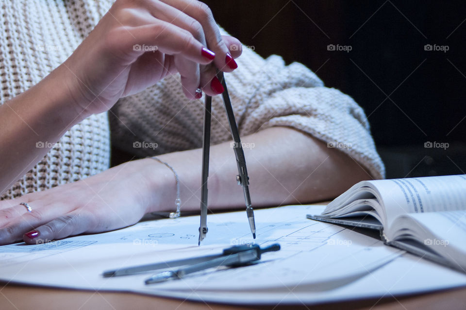 Girl draws a drawing compass