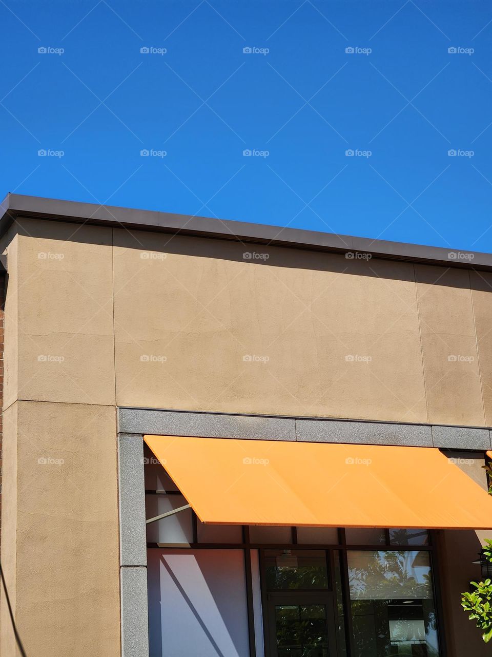 bright orange store front awning and blue sky