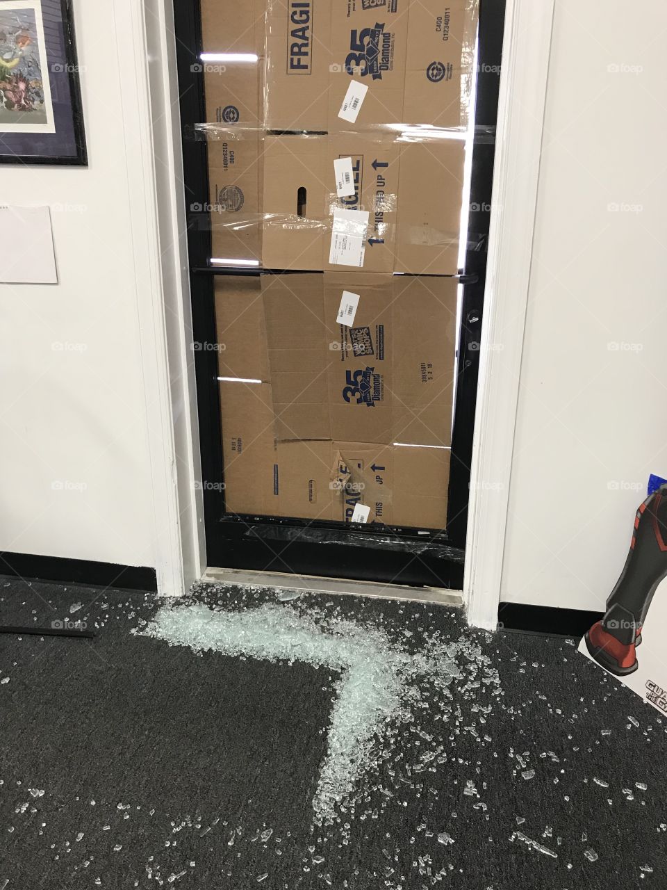 Smashed door covered in cardboard