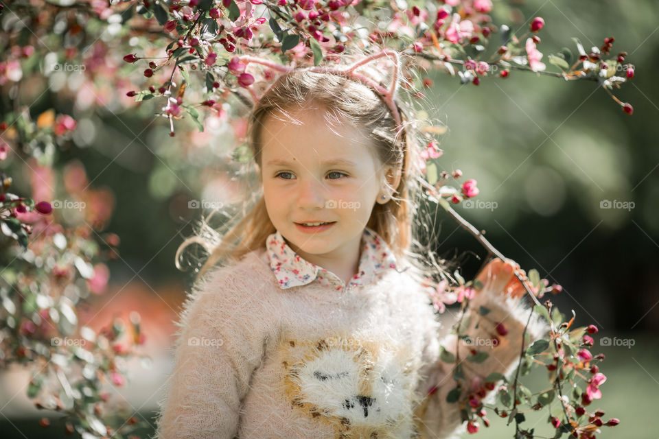 Cute Little girl in a blossom park