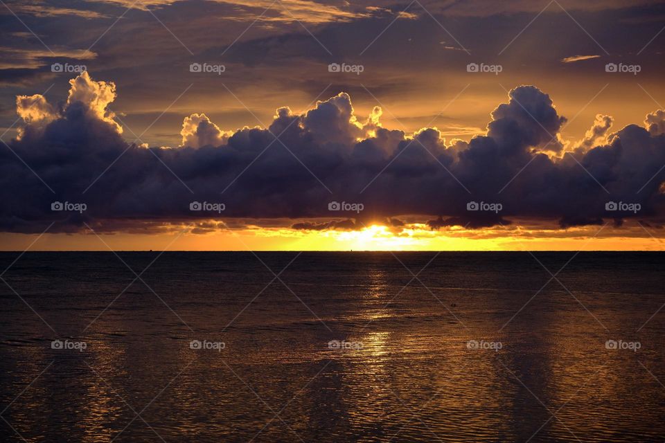 Dramatic sunset sky with clouds over the sea.