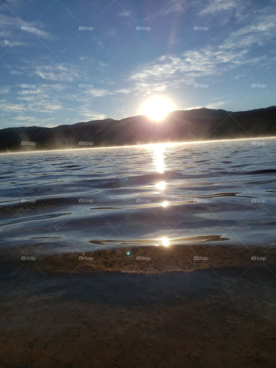 Early morning at Redfish Lake watching the sun rise. It looks beautiful as the light comes over the top of the mountains, and reflects on the crystal clear water. This is the beauty of Idaho.