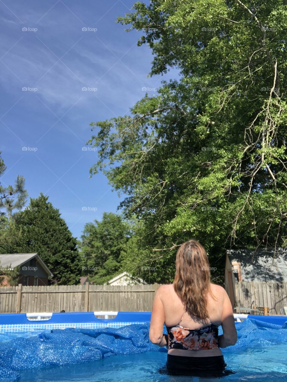 Sixty eight year old lady that is me in the pool showing back and long hair. 