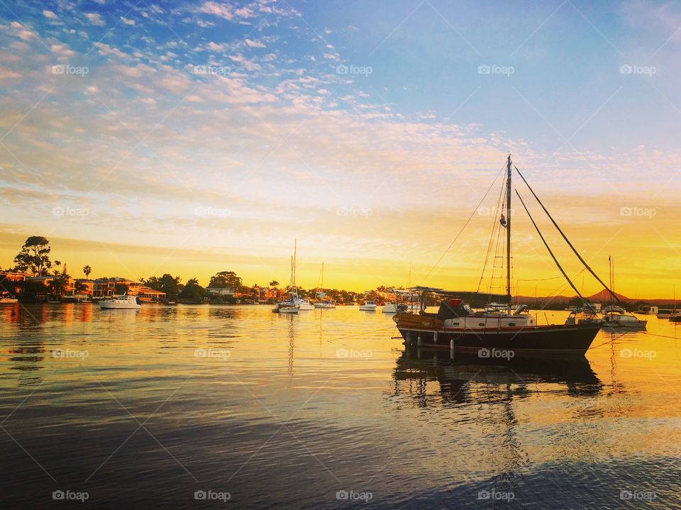 Sunset on the sea - boats in the water on a glassy sea - beautiful sunset reflections on the sea