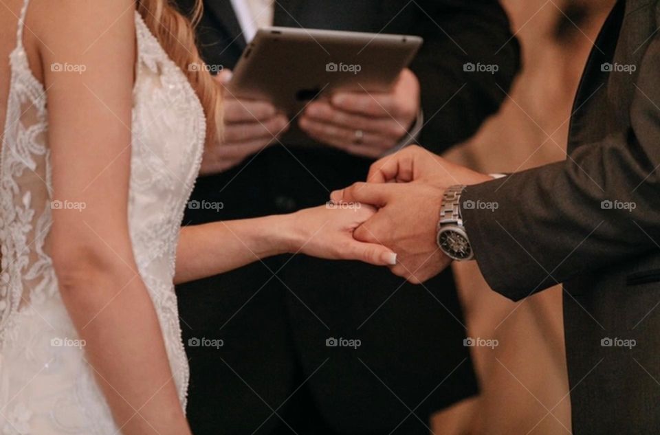 Putting ring on finger during wedding ceremony 