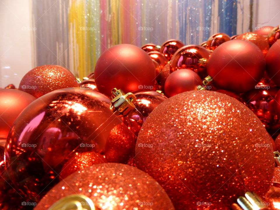 many decorative red balls stacked in a room with walls painted