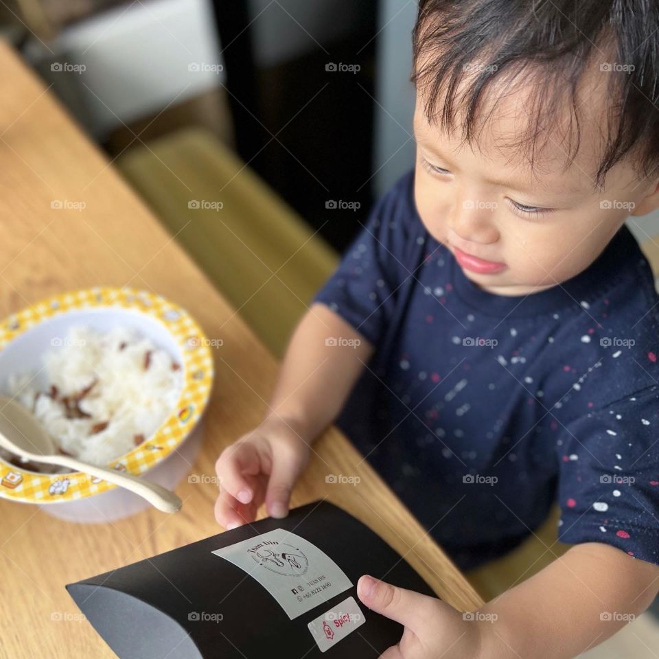 Asian kid trying out Tasty homemade Chicken grilled jerky 
