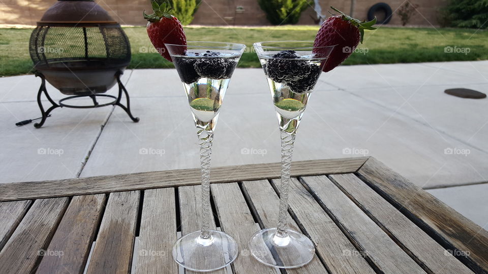 Champagne bubbles with fruit.  Back yard Happy Hour