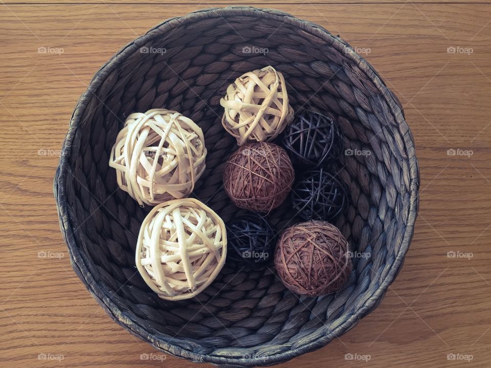 Wicker basket with a few wicker balls inside, home accessories 