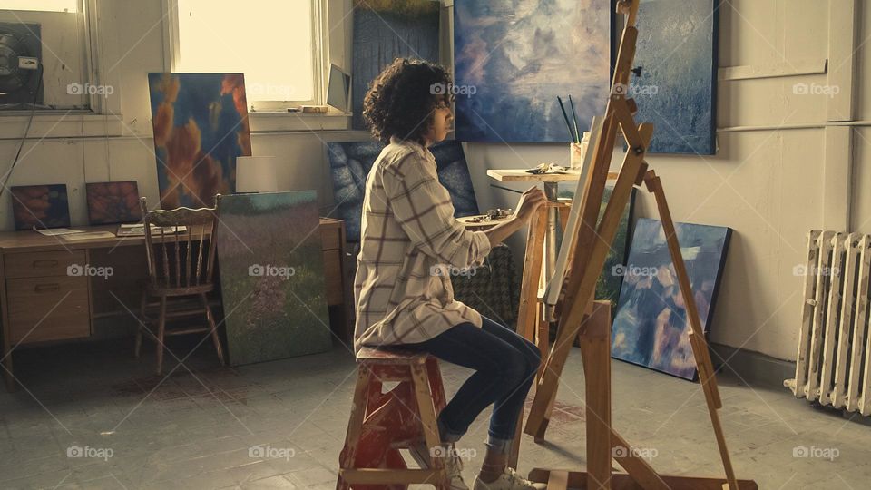 Painter Working In Studio