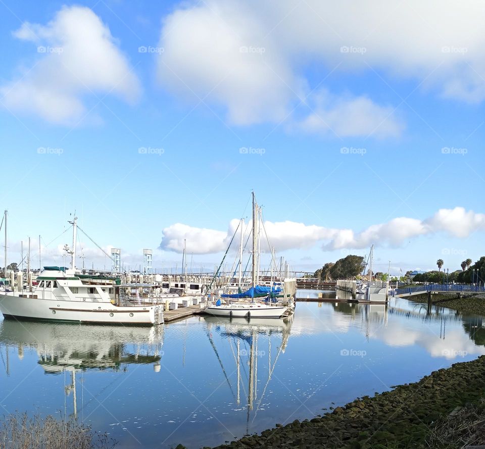 Landscape view  Of clouds and boats off the reflection of the water