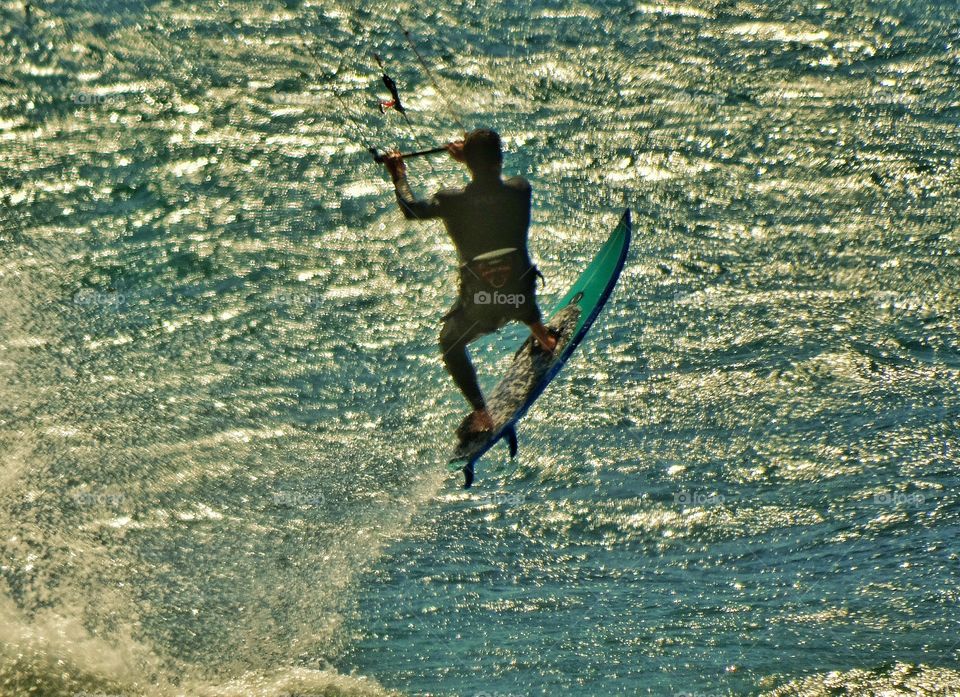 Flying On A Surfboard. California Surfer Flying Over A Wave
