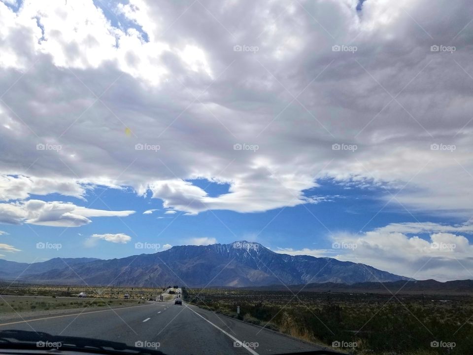 Road Trip IV: desert highway with mountains, clouds, and open space