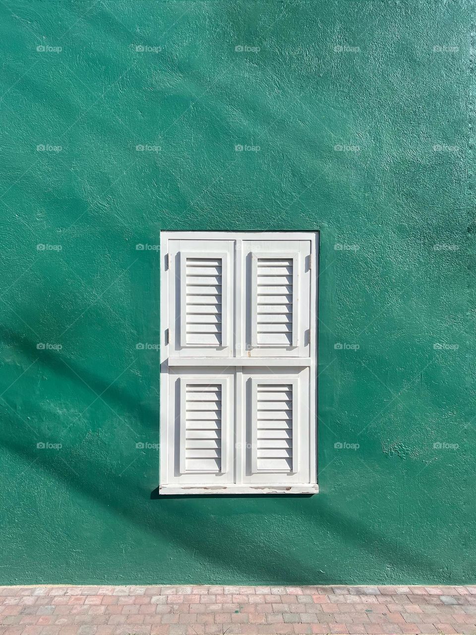 White shutters, green wall