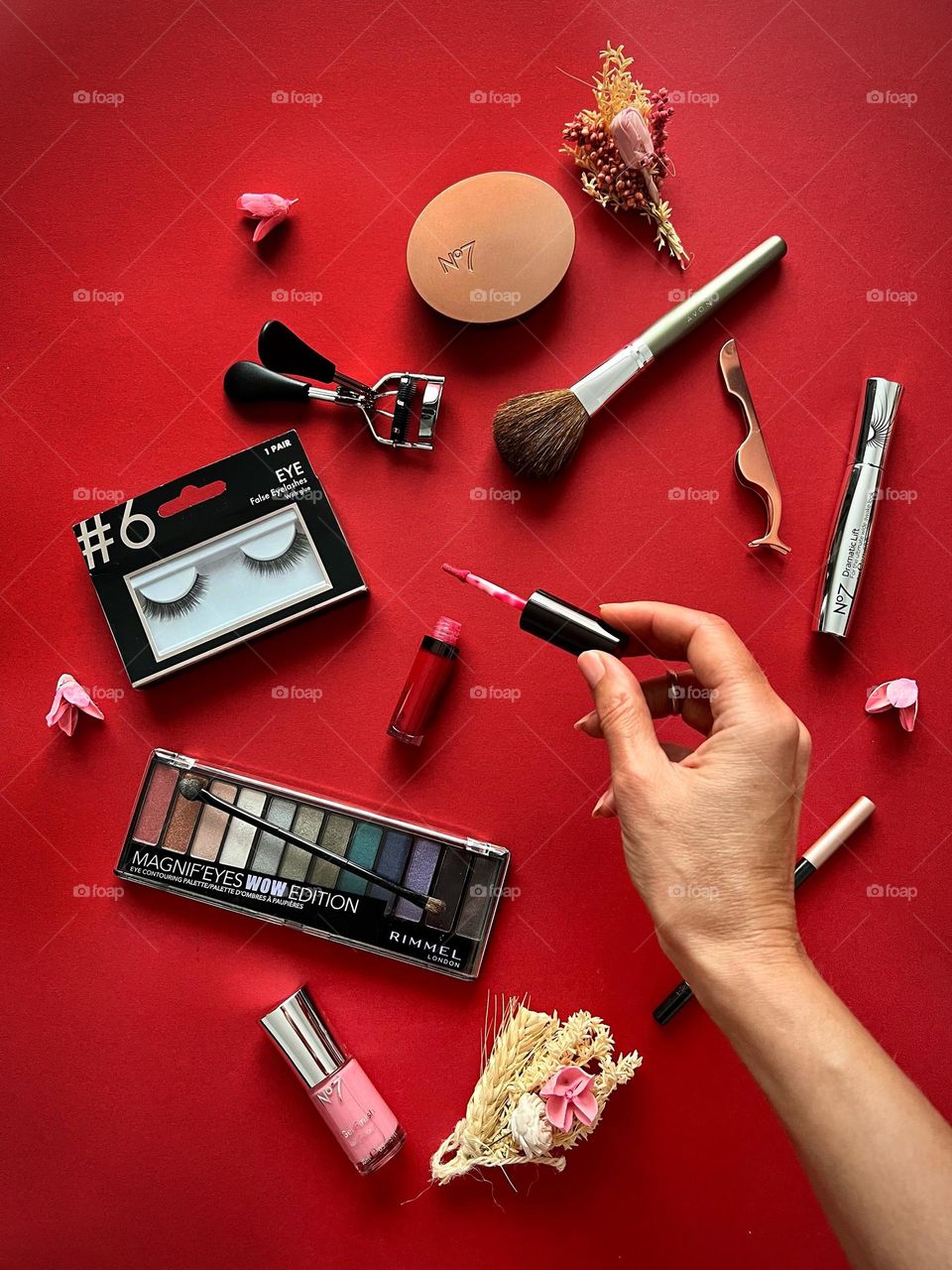 Decorating cosmetic, hand holding the red lipgloss, beauty brands.