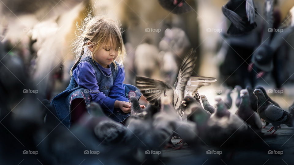 Cute girl with a group of bird