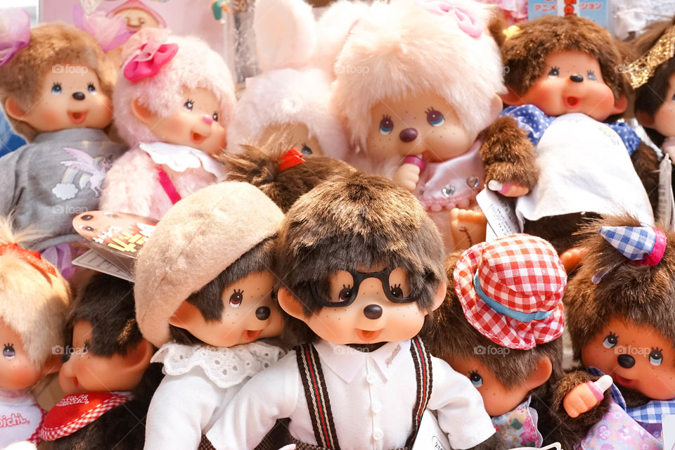 Bangkok, Thailand - August 20, 2017 : A pile of cute monkey plush dolls on display, stuffed animals.Selective focus on nerd glasses monkey doll called Monchhichi, Japanese character.Editorial use only