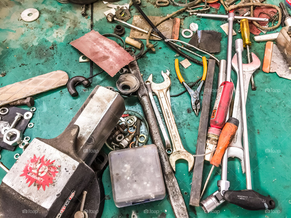 Set Of Different Hand Tools In A Workshop On Green Wooden Background
