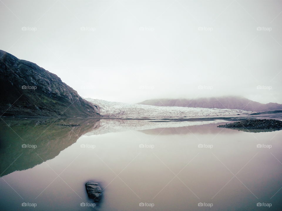 Mountain reflecting on lake during winter